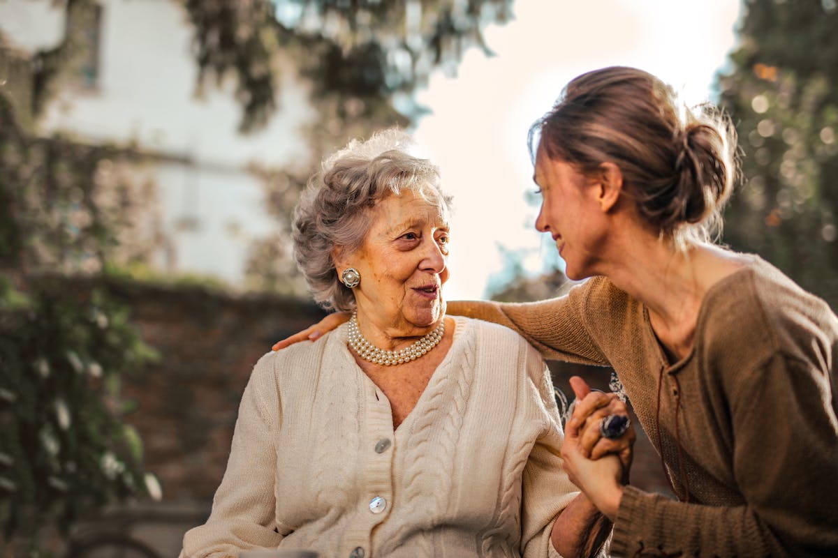 Compassionate caregiver with elderly woman
